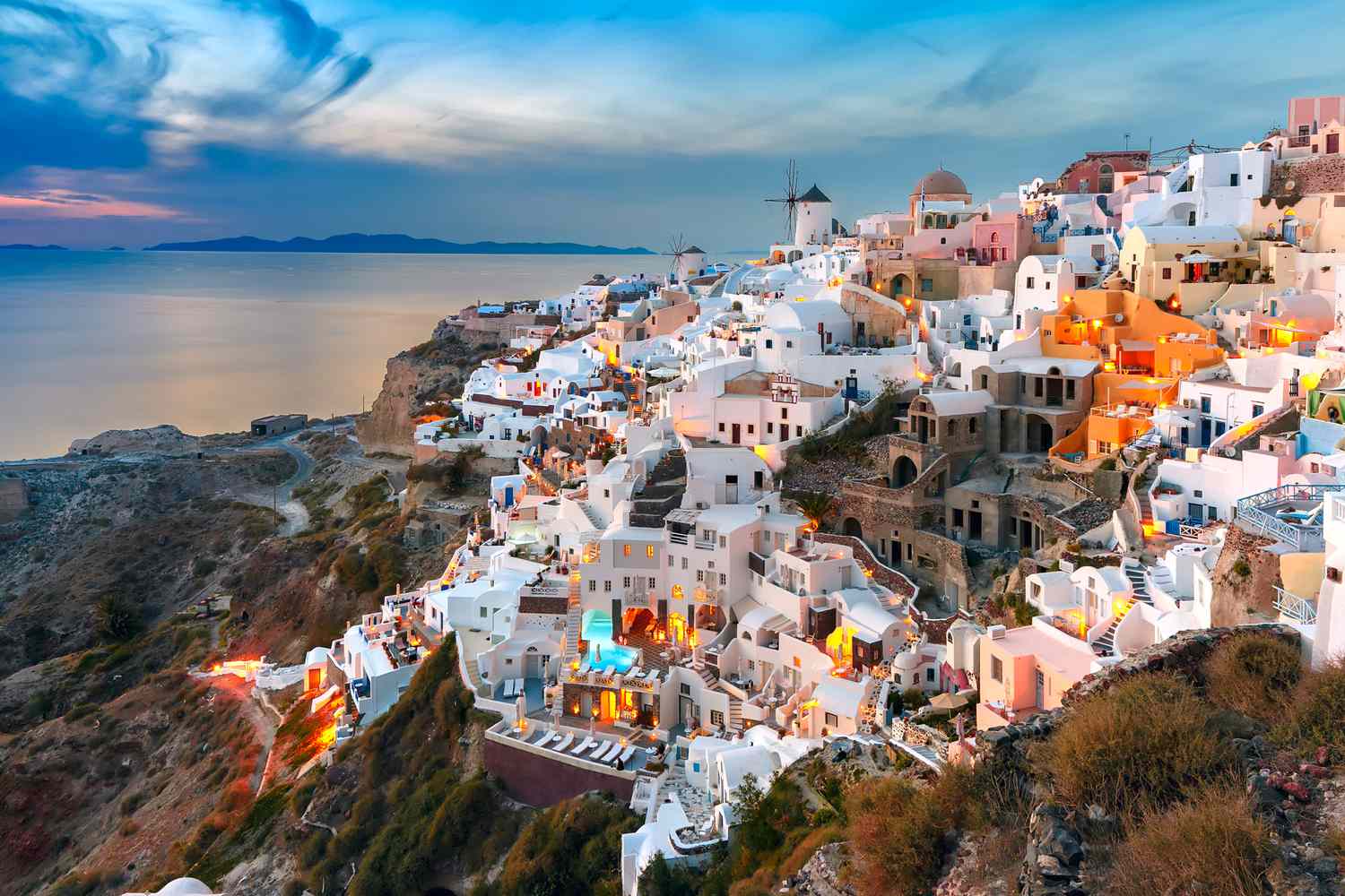 Cliffside view in Oia, Santorini, famous for luxury hotels, whitewashed architecture, and iconic caldera sunsets