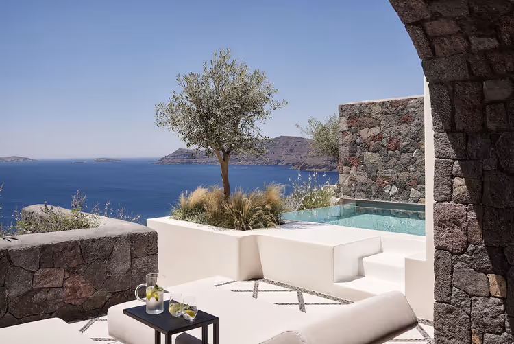 Private infinity pool suite at Canaves Oia Suites overlooking the Santorini caldera at sunset